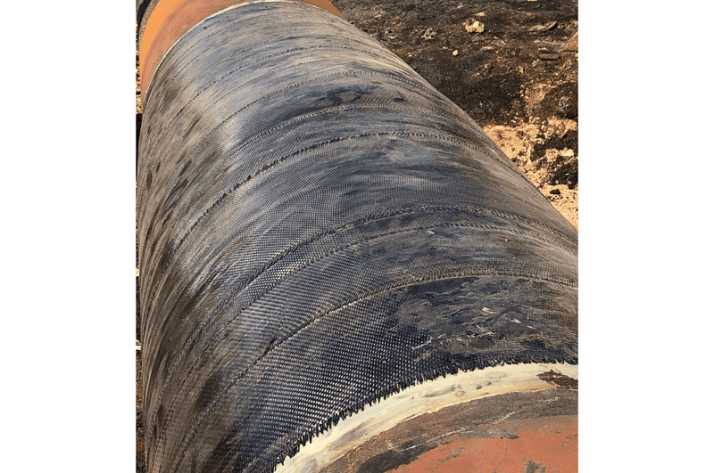 A line damaged in an explosion is wrapped with 26 layers of DiamondWrap and restored to safe service.